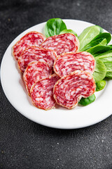 Dry-cured sausage salami appetizer dish fresh delicious gourmet food background on the table rustic food top view copy space
