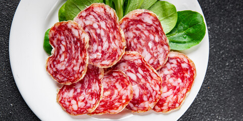 Dry-cured sausage salami appetizer dish fresh delicious gourmet food background on the table rustic...
