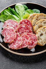 Dry-cured sausage salami appetizer dish fresh delicious gourmet food background on the table rustic food top view copy space