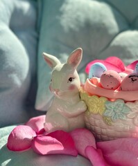 Decorative festive bunny with basket and colorful eggs