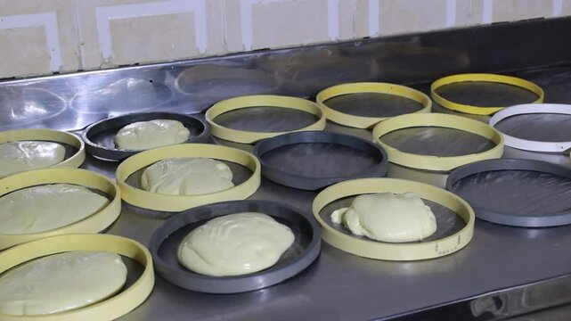 Hands of an unrecognizable person serving delicious Quesillos in circular molds at a restaurant in Yaguara, Huila, Colombia. Artisanal food concept