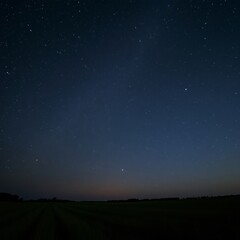 Observing Starry Night Sky over Dark Field Landscape at Twilight