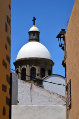 Fototapeta premium Aguimes, Gran Canaria. Tower of Parish Church of San Sebastian between traditional buildings. Spanish town in the eastern part of the island of Gran Canaria, Canary Islands.
