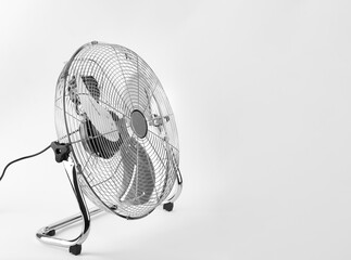 outdoor electric fan with metal safety net, photo on white background