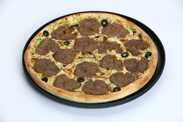 Varied pizzas on black plates with diverse toppings on a white background
