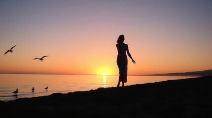 Fototapeta premium Silhouette of woman on beach, birds flying, soft light from sunset over the ocean, serene atmosphere