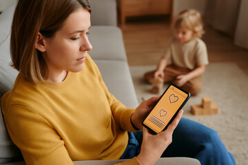 Mother using dating app on smartphone while child plays in background