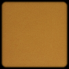 close up of blank brown flat sponge tile with rounded corners against black