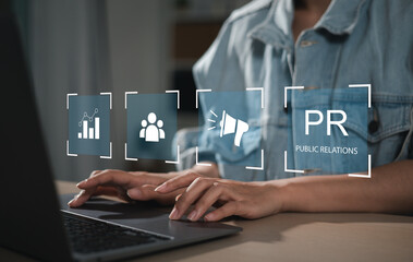 Businessman using laptop with public relations on virtual screen for marketing strategy, public...