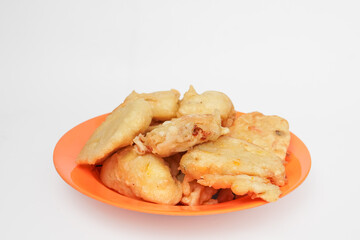 flour fried tofu on an orange plate isolated in white background