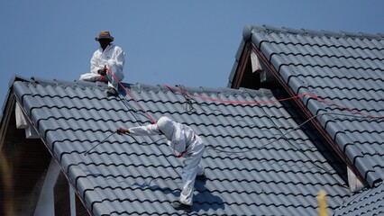 Professional painter on roof   Working at heights is dangerous.