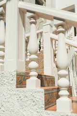Elegant white staircase flanked by classic pillars, architectural detail of a luxurious interior