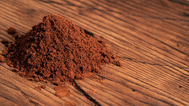 Arabica Coffee Beans Maragogipe on a Wooden Background. Elephant Beans with Ground Coffee