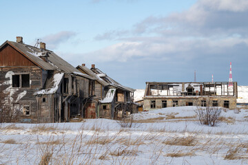 Old abandoned houses in the polar village of Teriberka on a March day. Murmansk region. Russia