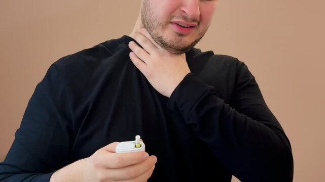 A man smokes an electronic cigarette and suddenly starts coughing.