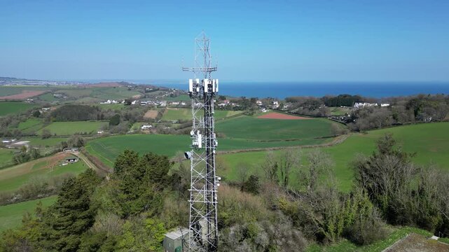 Torquay, Torbay, South Devon, England: DRONE VIEWS: Circling shots of a mobile network transmitter on Great Hill, Watcombe. Torbay is a popular UK holiday destination (Clip 1).