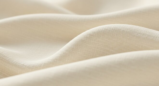 A close-up shot of soft, undulating, light-colored fabric with a subtle woven texture