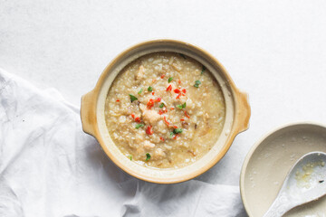 Top view of rice and chicken porridge in a claypot