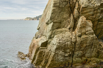 Majestic Rock Formations by the Ocean Under a Cloudy Sky at a Coastal Location