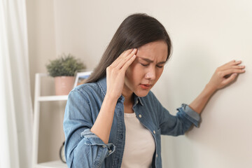 Young Asian females feeling dizzy after standing too fast, have symptoms of low blood pressure