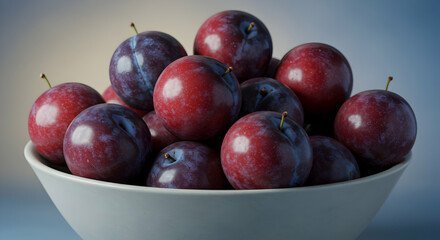 Obraz premium Pile Of Plums In White Bowl