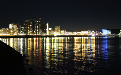 Night view of Reykjavik city lights reflected in the water