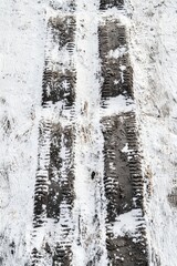 Obraz premium Vertical abstract view of tire tracks in muddy motocross course or skis carving through fresh snow textures
