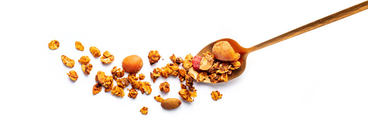 Granola in a spoon on a white background, panorama. Organic gourmet muesli, shot from the top