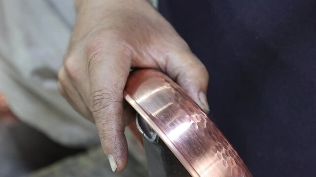 Traditional coppersmithing in Gaziantep. Craftsman engraving on a copper metal plate