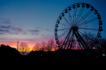 Ferris wheel silhouette at twilight