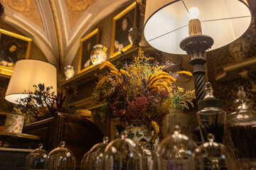Dimly lit interior with lamps and decorative items