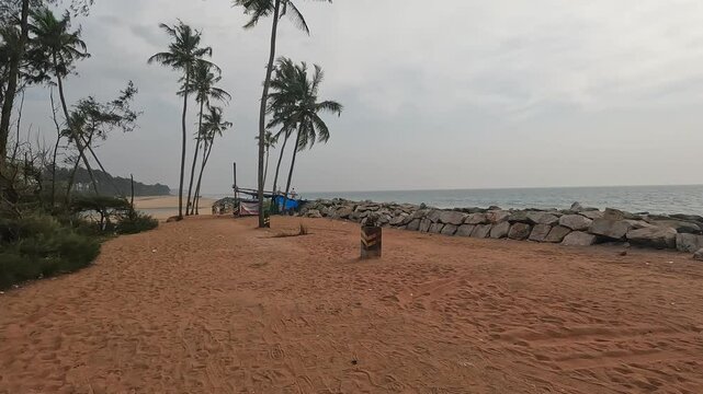 Freshwater lake meets the sea at Kappil Beach near Varkala, India. against a cloudy skies, tropical nature, and rare coastal serenity in one scenic view.