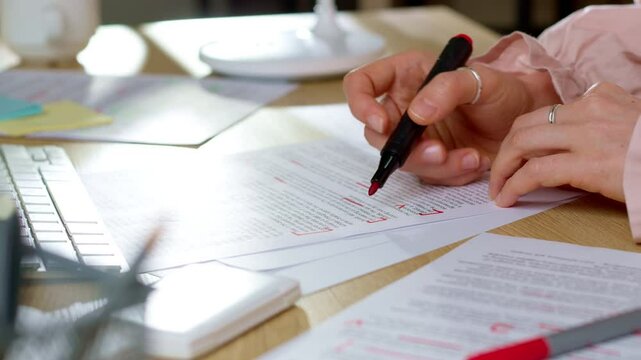 The woman works with the text as a translator or scriptwriter. The editor marks words on paper.