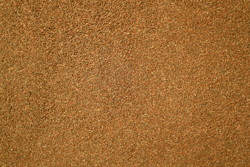 Macro fragment of the texture of stucco plaster concrete wall, decorated with grainy sand surface. wall pattern cement brown red background abstract pink color design light backdrop