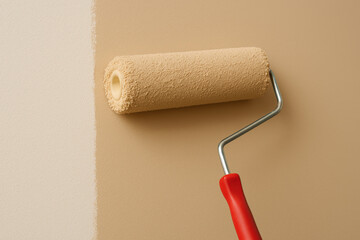 Fototapeta premium Painting wall with beige roller brush during home interior renovation