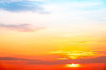 Obraz premium Sky,sunset, beautiful , luxury soft gradient orange gold clouds and sunlight on the blue sky perfect for the background, Sunrise on morning or everning in winter warm time ,Twilight summer,silhouette