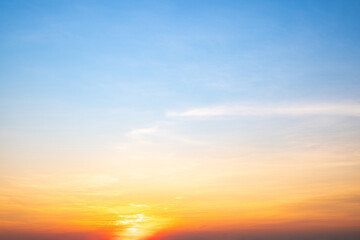 Fototapeta premium Sky,sunset, beautiful , luxury soft gradient orange gold clouds and sunlight on the blue sky perfect for the background, Sunrise on morning or everning in winter warm time ,Twilight summer,silhouette