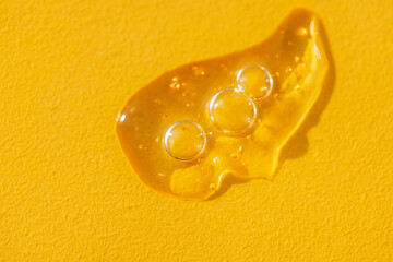 Extremely close-up view of a transparent gel with bubbles and colloidal gold. Cosmetic products