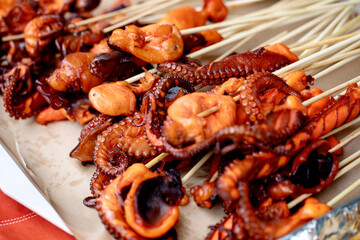 Grilled Octopus Skewers on Wooden Board