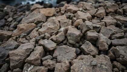 Fototapeta premium pile of rocks sitting next to a body of water