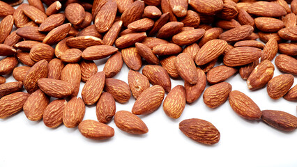Top view of almonds on a clean white background. Highlighting their natural brown tones and smooth, oval shapes