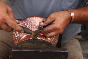 Traditional coppersmithing in Gaziantep. Craftsman engraving on a copper metal plate