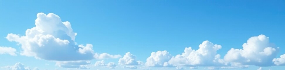 Fototapeta premium Puffy white clouds scattered across the bright clear blue sky, blue sky, gentle