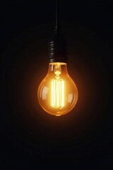 Softly glowing light bulb suspended in mid-air against a dark background, glow, backlighting, retro