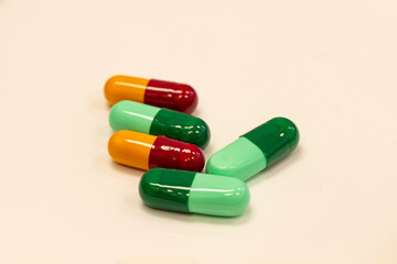 Different pills falling on black background. Drugs, pills, antibiotics, vitamins, healthcare, pharmaceutical industry, drug use, medicine concept.