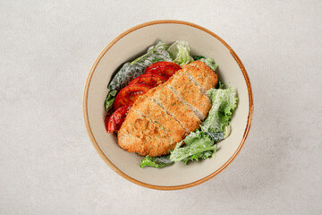 Portion of chicken schnitzel with fresh vegetables
