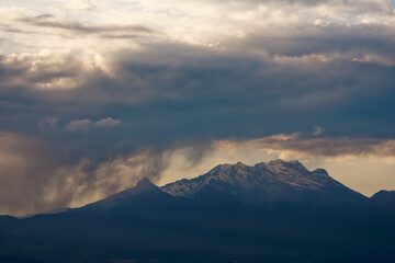 Iztaccihuatl volcano in Mexico with beautiful light blue fluffy clouds
