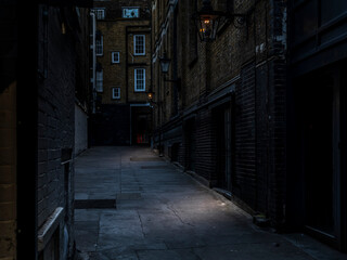 A mysterious, grimy and hidden old back alley in London at night