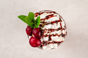 Glass of sweet fresh cherry milkshake with mint