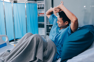 Lonely man silhouette sitting on the bed feeling depressed and stressed in the dark bedroom, Depression and anxiety disorder concept